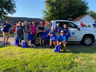 Group of people standing in front of a truck