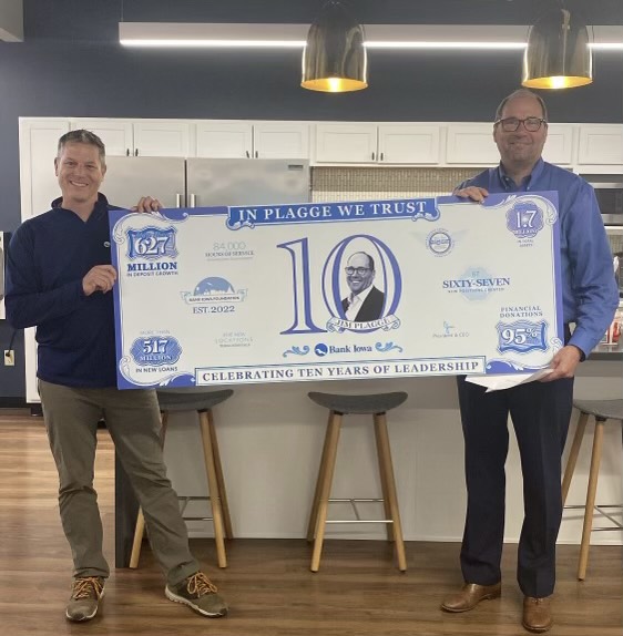 Two men holding giant check