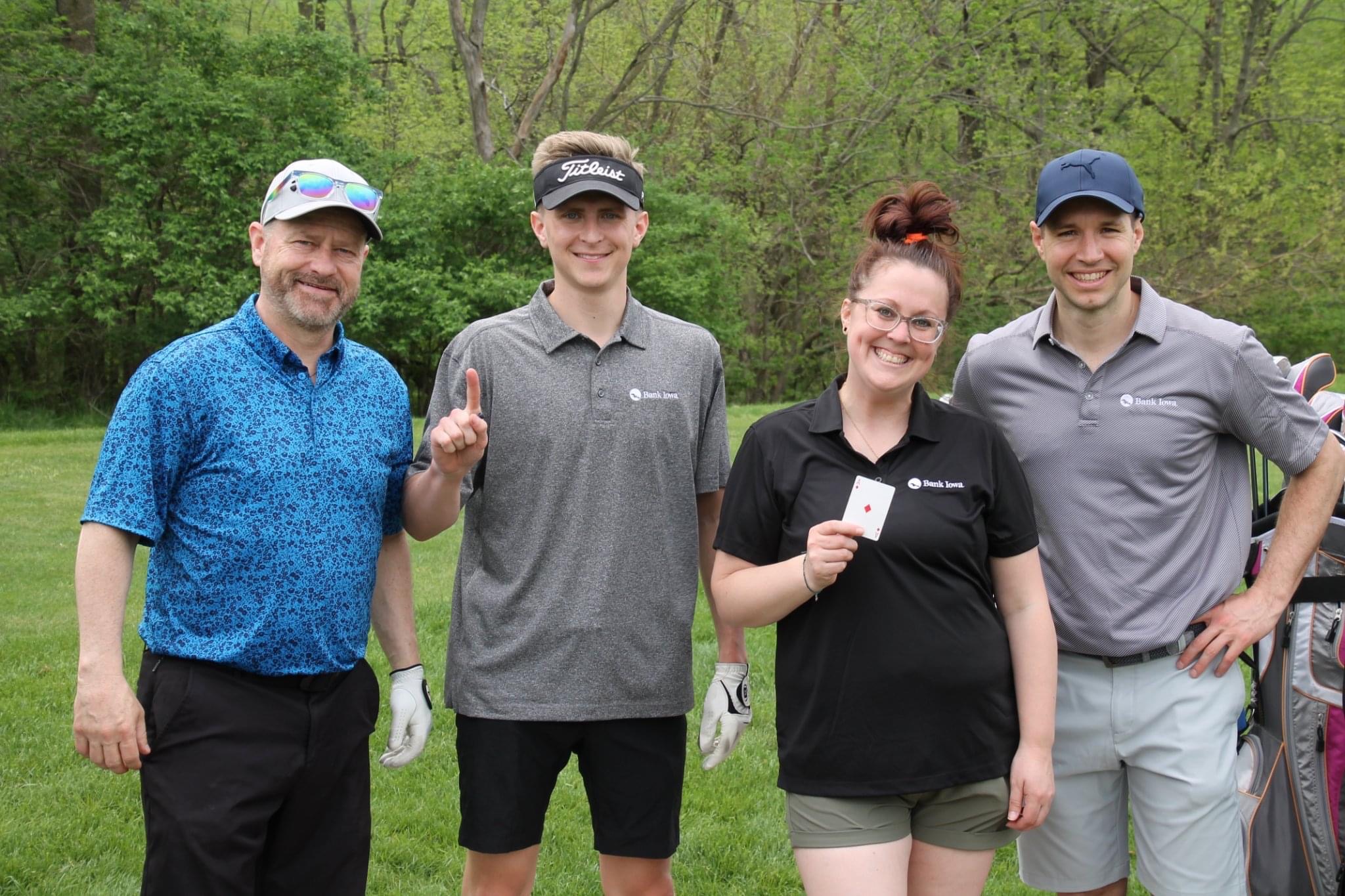 People standing on golf course smiling