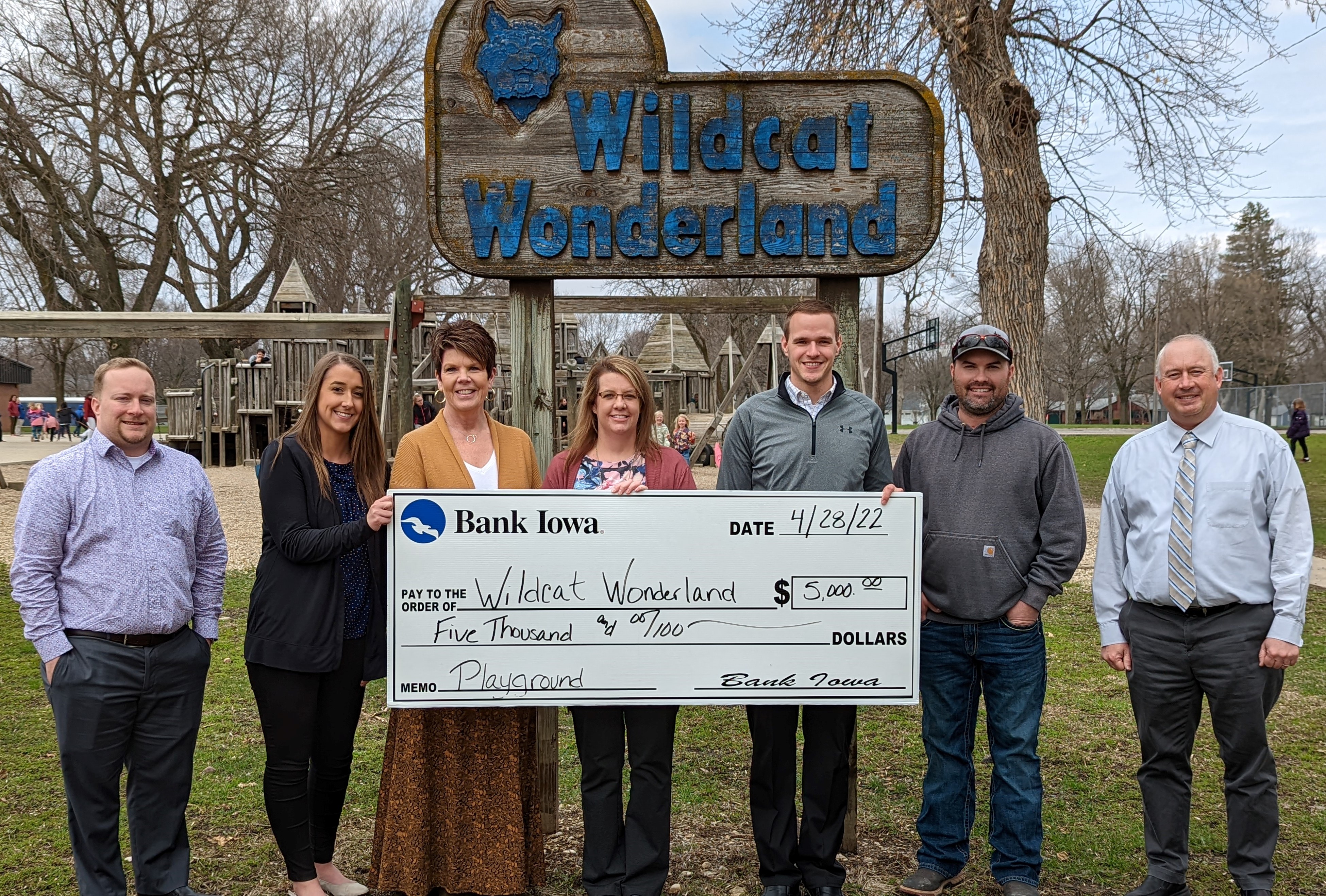 Bank Iowa Humboldt team members holding a giant check