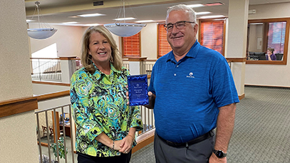 Margaret Burns received award from John McBride