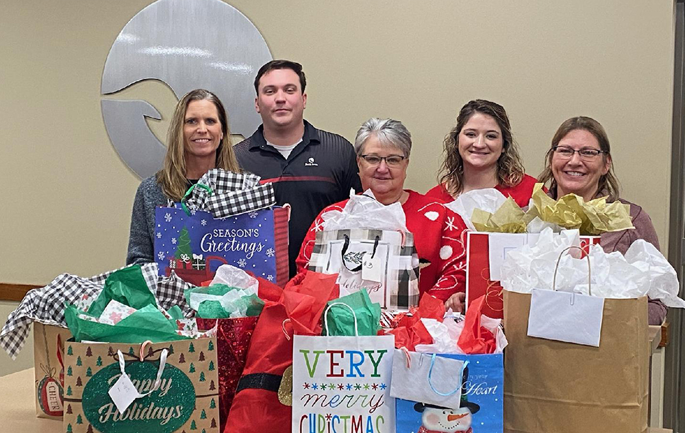 Shenandoah employees with the gifts they are giving to 